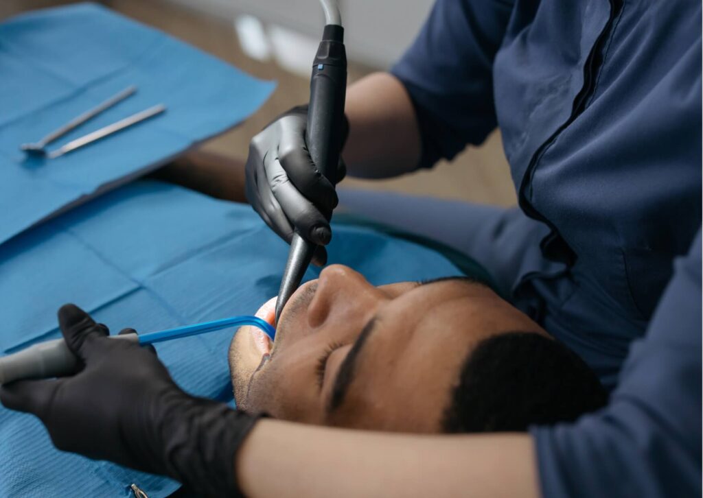 Patient receiving a dental examination and cleaning, highlighting how plaque buildup and poor oral hygiene can contribute to gum recession.