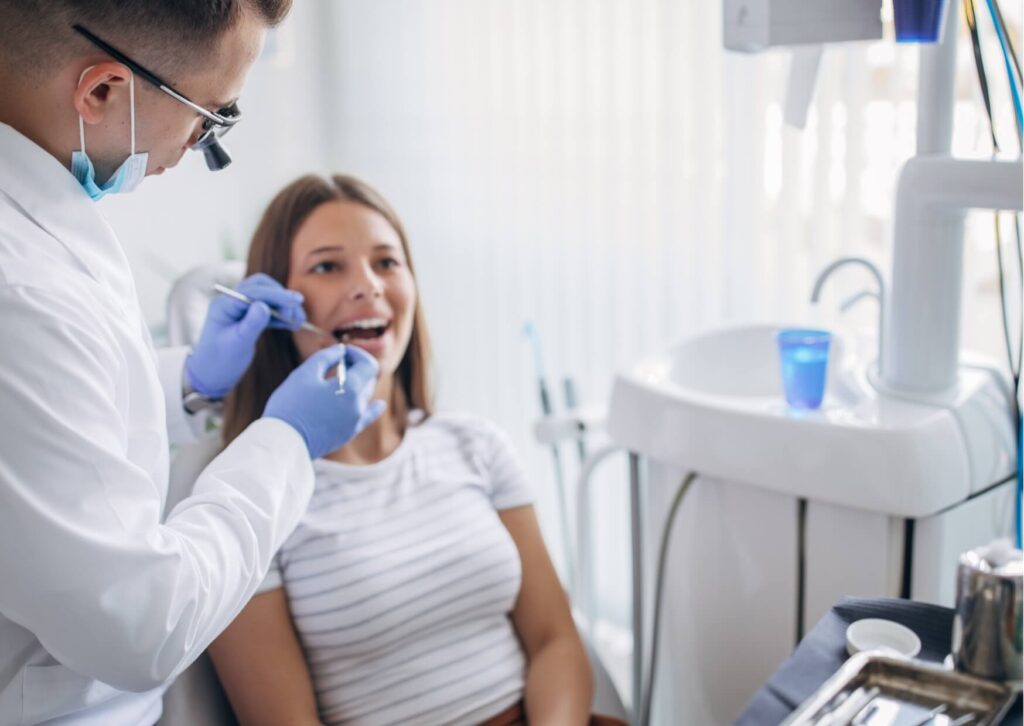 Dentist examining a patient's gums during a dental checkup to diagnose gingivitis and recommend treatment options.