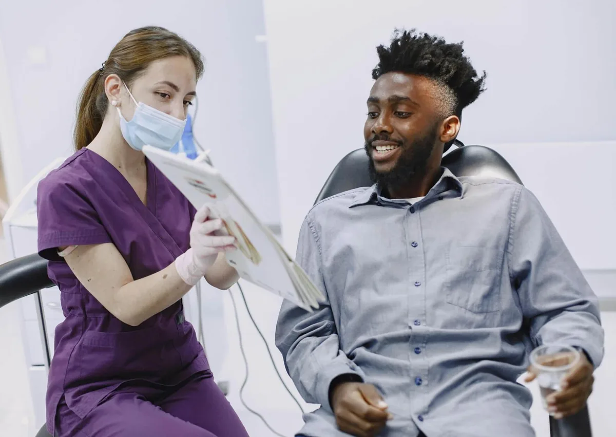 Dental professional discussing sleep apnea treatment options with a patient during a consultation.